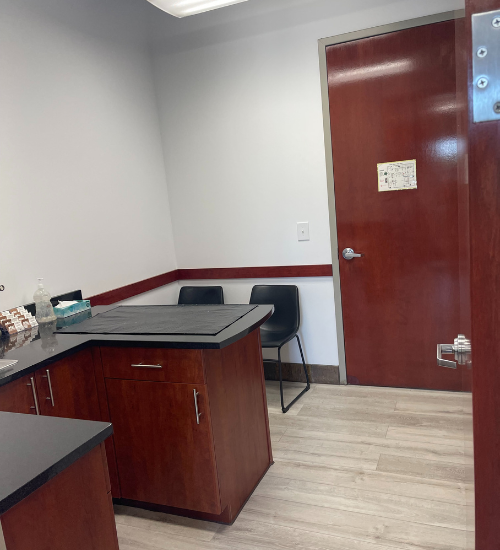 A small office with a desk and cabinets